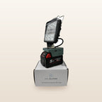 Milwaukee-compatible 18V LED Camp Light: on an 18V battery, standing on its box