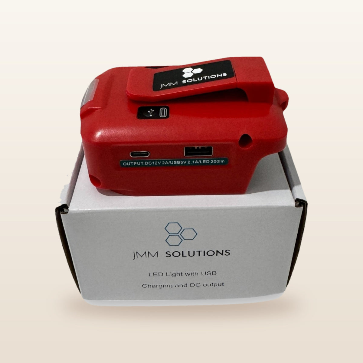 Milwaukee-compatible USB & 12V Charger with LED Light: standing on its box