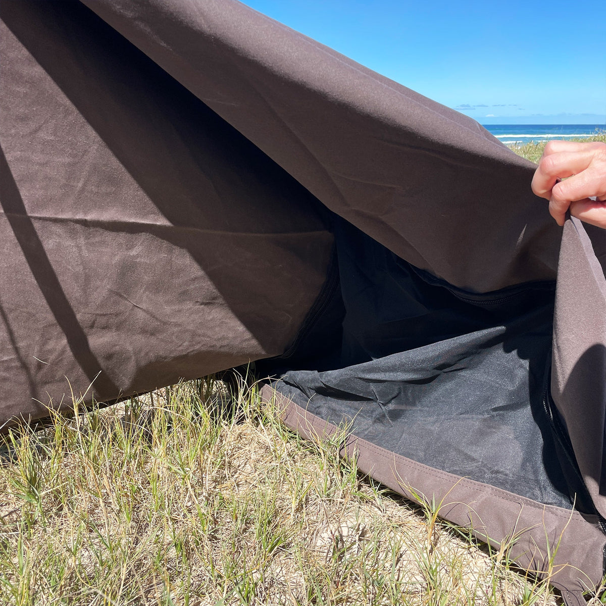 Lifting the Classic King Single Swag's canvas to show the mesh and mattress inside