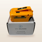DeWalt-compatible USB & 12V Charger with LED Light: standing on its box