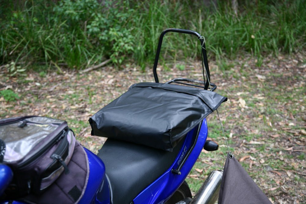Packed Premium Canvas Tarp strapped to the back seat of a motorbike