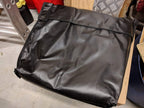 Premium Canvas Tarp folded into its black PVC storage bag