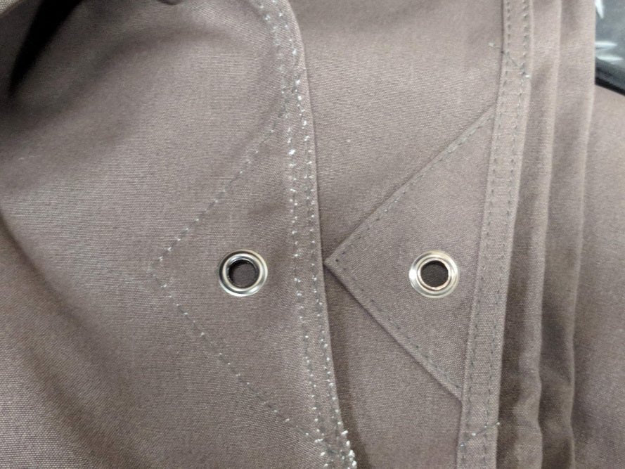 Close-up of the reinforced corner and eyelets on the canvas tarp