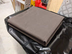Premium Canvas Tarp folded on top of its PVC storage bag