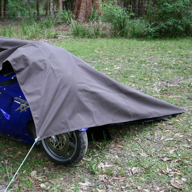 Premium Canvas Tarp covering a motorbike, pegged out with a guy rope