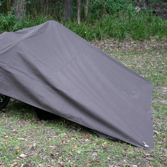 Mr Swagman Premium Canvas Tarp 3m x 3m pitched as a lean-to shelter in the bush