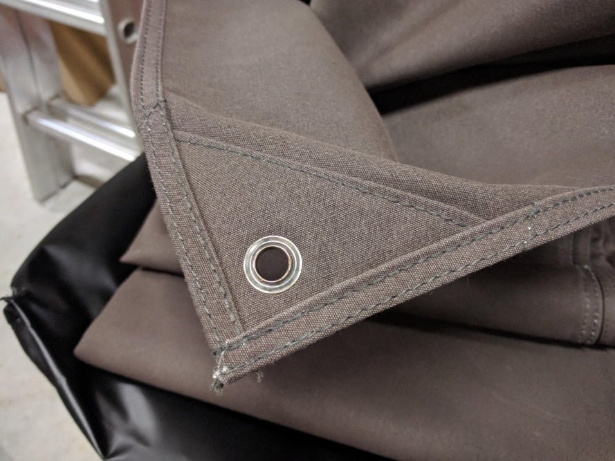 Brass eyelet in a reinforced corner of the Premium Canvas Tarp