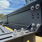 Shelta 270 rear L-bracket and bolts on the roof rack, under the hinge end of the awning