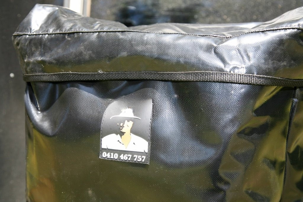 Close-up of the Mr Swagman logo on the black PVC spare wheel bag