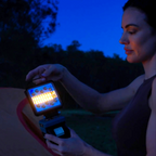 Milwaukee-compatible 18V LED Camp Light: woman switching on the light outdoors at dusk