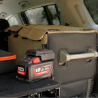 Milwaukee-compatible 18V to 12V Power Supply + Auto Charger Bundle: in use on a battery in the back of a vehicle
