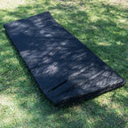 80mm foam mattress from the Ultimate King Single Swag laid on grass