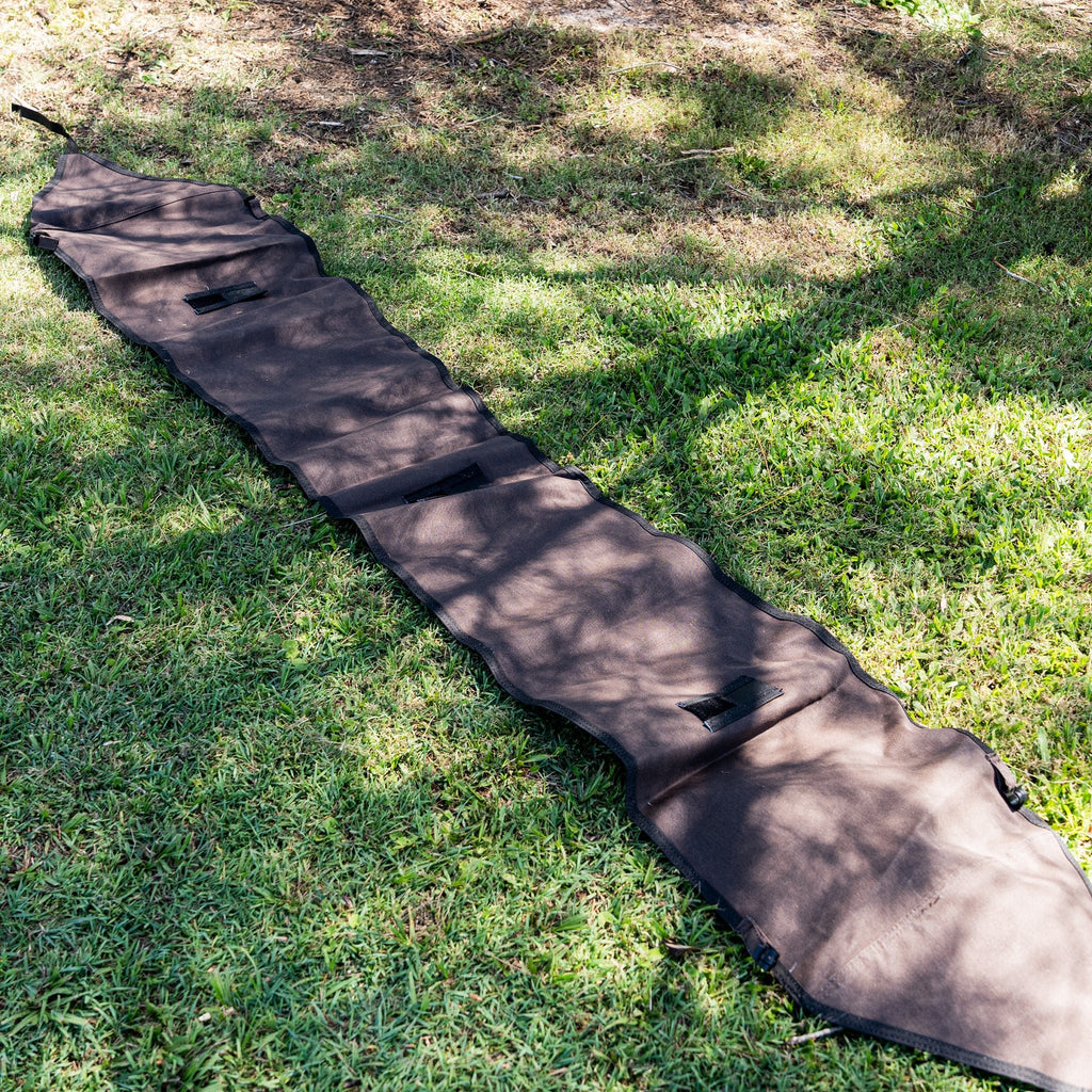 Full-length canvas rainfly laid flat on grass