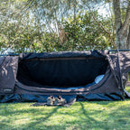 Ultimate King Single Swag on grass with the insect mesh door open